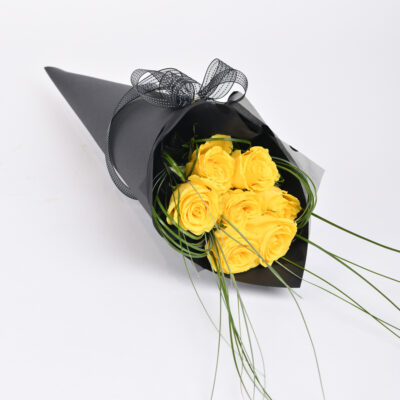Yellow roses in an elegant black box