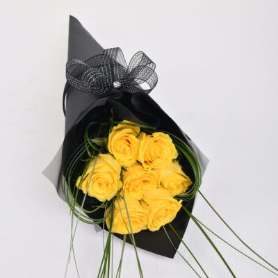 Yellow roses in an elegant black box