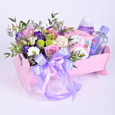 A pink cradle full of flowers